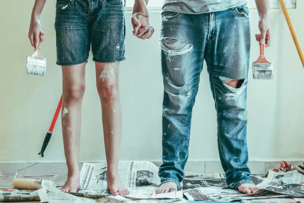 Couple working together on a home painting project